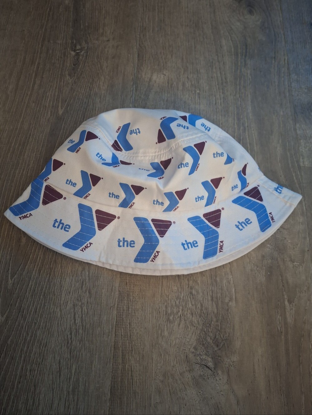 white polyester bucket hat with blue and maroon YMCA logo pattern #buckethat #ym